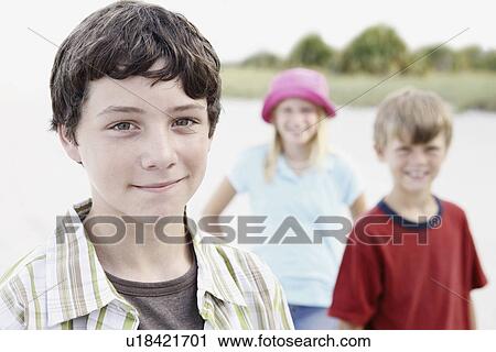 Stock Image - Children posing on beach. Fotosearch