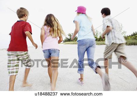 Stock Photo - Children running on beach. Fotosearch
