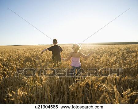 Stock Photography - Children running through tall wheat field. Fotosearch