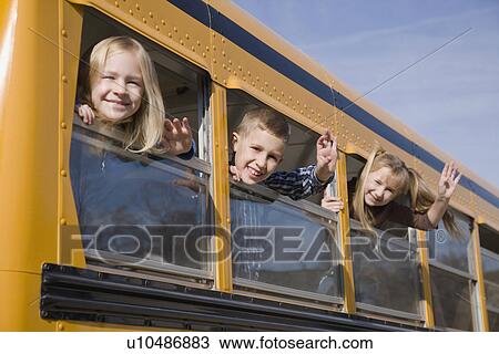 Stock Image - Children waving from school bus windows. Fotosearch