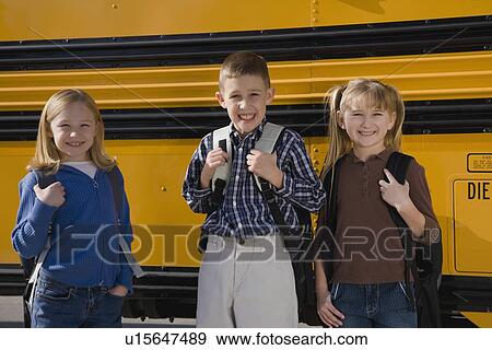 Children with back packs in front of school bus View Large Photo Image Stock Photo - Children with back packs in front of school bus. Fotosearch