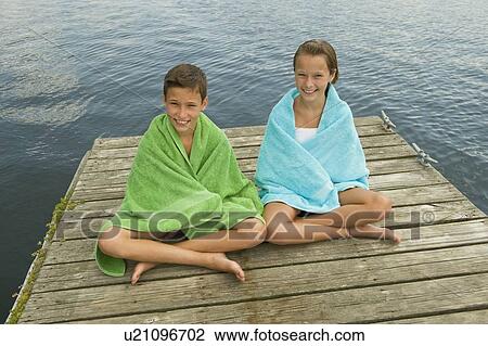 Children wrapped in towels on dock View Large Photo Image Stock Image - Children wrapped in towels on dock. Fotosearch