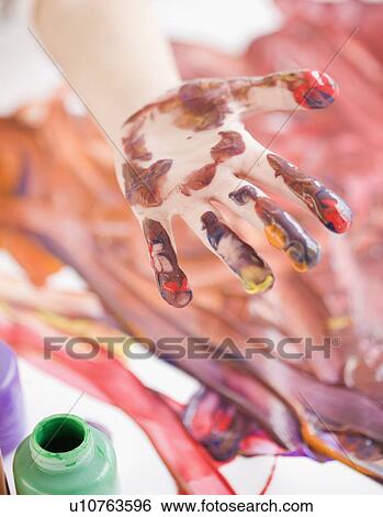 Stock Photograph - Child’s hand covered in paint. Fotosearch