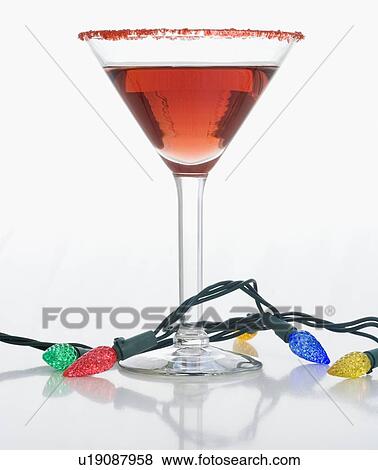 Christmas lights around cocktail glass View Large Photo Image Stock Photo - Christmas lights around cocktail glass. Fotosearch