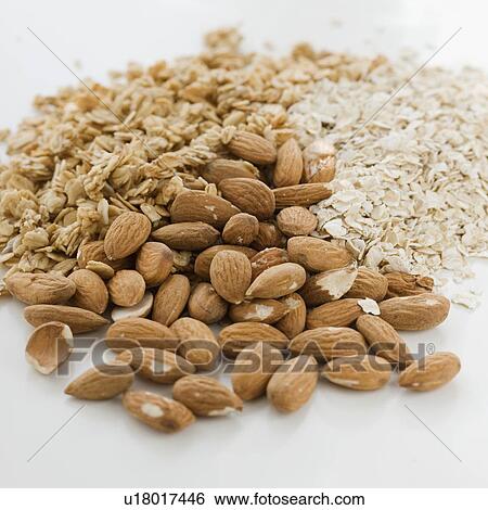 Stock Photograph - Close up of almonds, granola and oats. Fotosearch