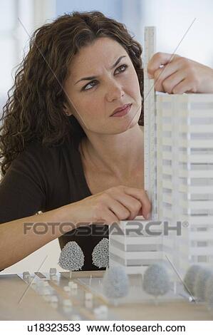 Close up of architect measuring building model View Large Photo Image Stock Image - Close up of architect measuring building model. Fotosearch