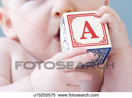 Close up of baby biting on alphabet block View Large Photo Image Stock Photography - Close up of baby biting on alphabet block. Fotosearch