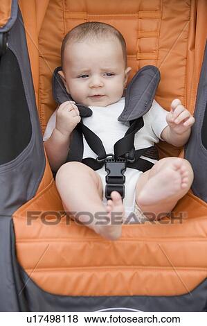 Close up of baby boy in stroller View Large Photo Image Stock Photo - Close up of baby boy in stroller. Fotosearch