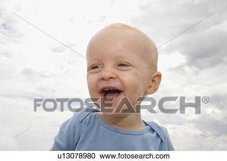 Stock Image - Close up of baby boy laughing. Fotosearch