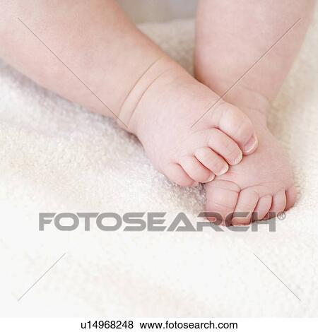Stock Photo - Close up of baby’s feet. Fotosearch