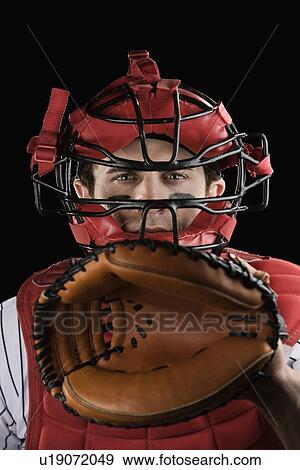 Stock Photo - Close up of baseball catcher wearing protective equipment. Fotosearch