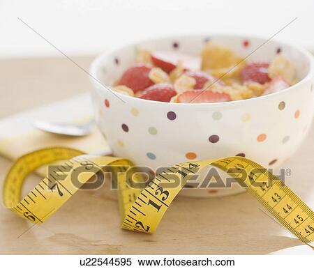 Close up of cereal and measuring tape View Large Photo Image Stock Photography - Close up of cereal and measuring tape. Fotosearch