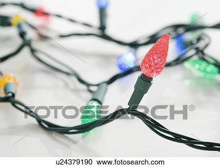 Stock Image - Close up of Christmas lights. Fotosearch