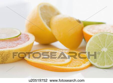 Stock Image - Close up of citrus fruit slices. Fotosearch