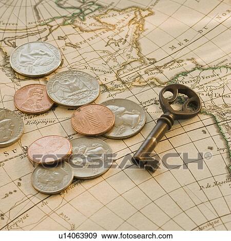 Close up of coins and key on map View Large Photo Image Stock Photo - Close up of coins and key on map. Fotosearch
