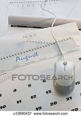 Stock Photo - Close up of computer mouse on calendar. Fotosearch