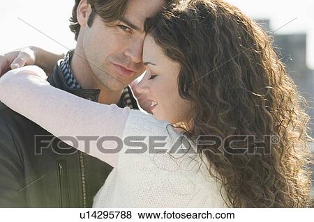 Stock Photo - Close up of couple hugging. Fotosearch