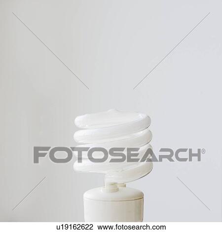 Stock Image - Close up of energy efficient light bulb. Fotosearch