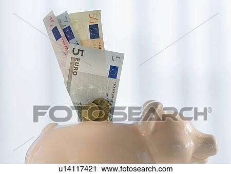Close up of euros sticking out piggybank View Large Photo Image Stock Image - Close up of euros sticking out piggybank. Fotosearch