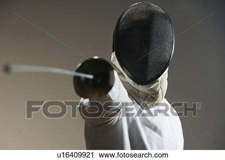 Close up of fencer in mask pointing fencing foil View Large Photo Image Stock Image - Close up of fencer in mask pointing fencing foil. Fotosearch
