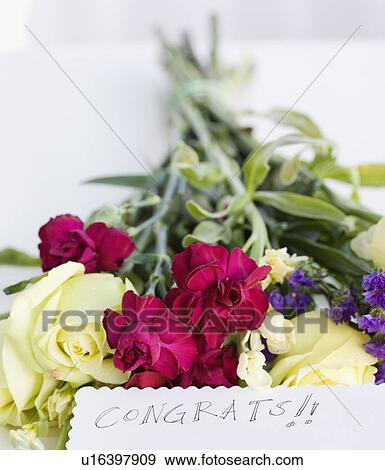 Stock Photo - Close up of flower bouquet and note. Fotosearch