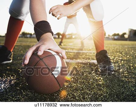 Close up of football center preparing to snap football View Large Photo Image Stock Image - Close up of football center preparing to snap football. Fotosearch