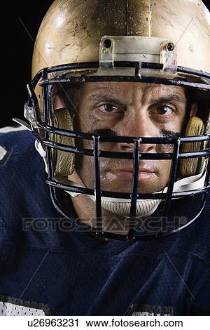 Stock Image - Close up of football player looking serious. Fotosearch