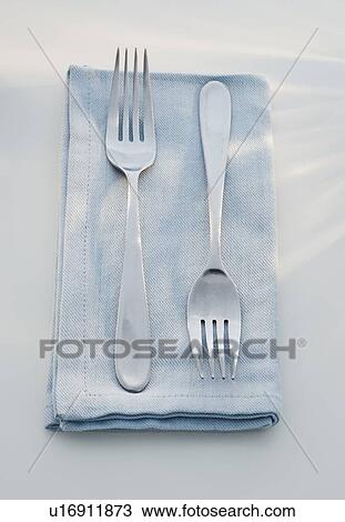 Stock Image - Close up of forks on napkin. Fotosearch