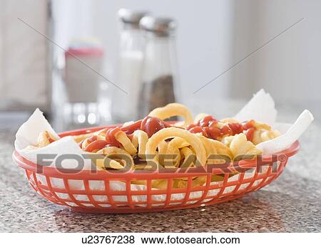 Stock Photo - Close up of French fries and ketchup in basket. Fotosearch