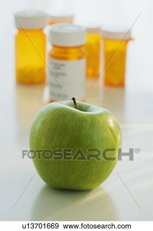 Close up of green apple with prescription bottles in background View Large Photo Image Stock Photo - Close up of green apple with prescription bottles in background. Fotosearch
