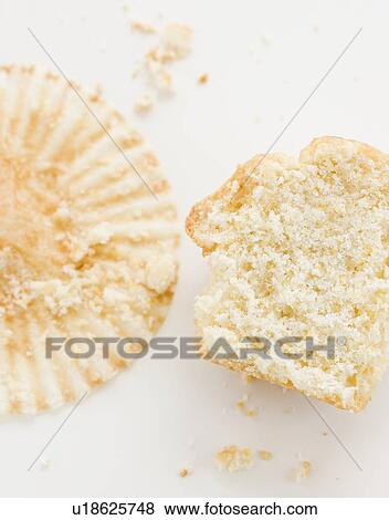 Stock Photo - Close up of half eaten muffin and wrapper. Fotosearch