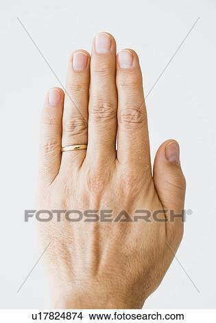 Close up of man’s hand wearing wedding ring View Large Photo Image Picture - Close up of man’s hand wearing wedding ring. Fotosearch