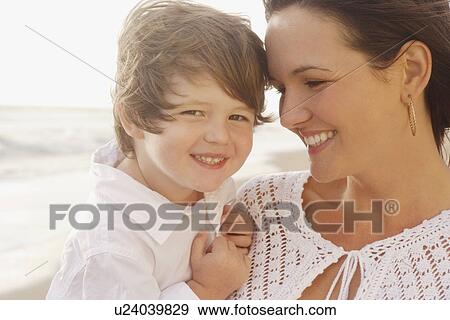 Stock Photo - Close up of mother and son smiling. Fotosearch