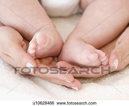 Close up of mother’s hands and baby’s feet View Large Photo Image Stock Photograph - Close up of mother’s hands and baby’s feet. Fotosearch