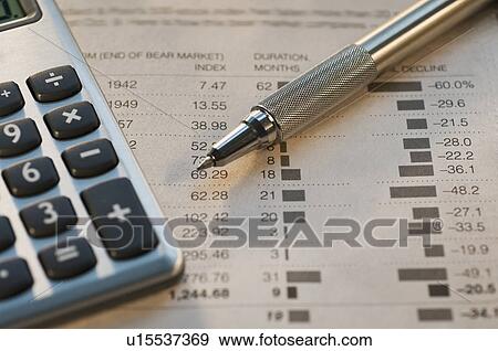 Stock Photo - Close up of pen, calculator and financial pages. Fotosearch