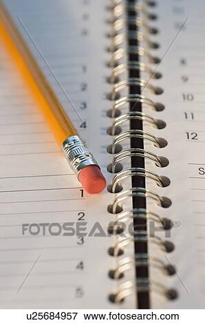 Stock Photo - Close up of pencil and notebook. Fotosearch