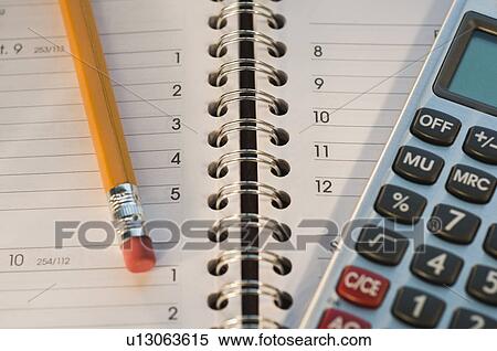 Stock Photography - Close up of pencil, notebook and calculator. Fotosearch