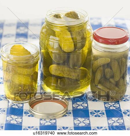 Stock Image - Close up of pickles in jars. Fotosearch