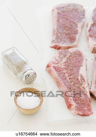 Close up of raw steaks and seasoning View Large Photo Image Picture - Close up of raw steaks and seasoning. Fotosearch