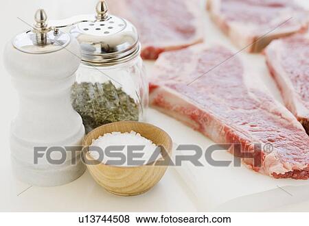 Close up of raw steaks and seasoning View Large Photo Image Stock Photo - Close up of raw steaks and seasoning. Fotosearch