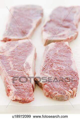 Close up of raw steaks View Large Photo Image Stock Photo - Close up of raw steaks. Fotosearch