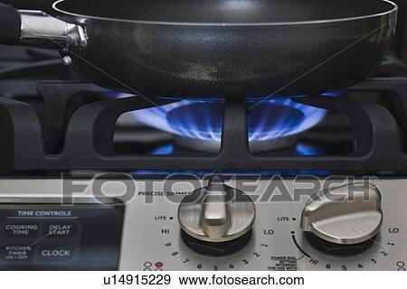 Stock Photo - Close up of skillet on gas stove. Fotosearch