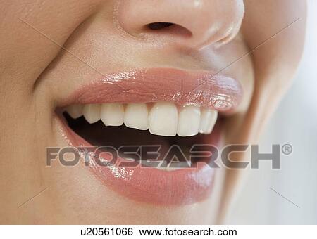 Stock Photograph - Close up of smiling woman’s mouth. Fotosearch