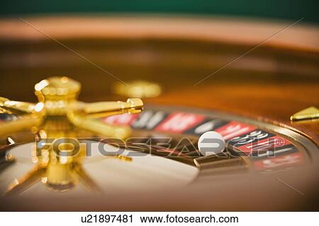 Stock Image - Close up of spinning roulette wheel. Fotosearch