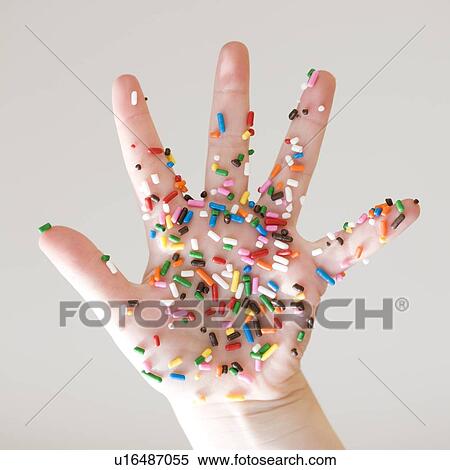 Stock Photography - Close up of sprinkles on child’s hand. Fotosearch
