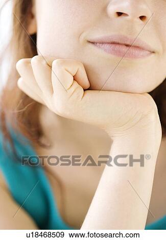 Stock Photo - Close up of teenage girl resting head in hand. Fotosearch
