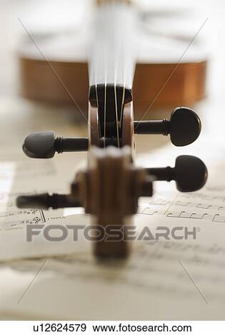 Stock Photo - Close up of violin bow on sheet music. Fotosearch