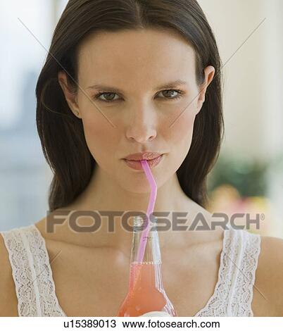 Close up of woman drinking soda from a straw View Large Photo Image Stock Image - Close up of woman drinking soda from a straw. Fotosearch