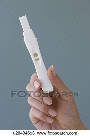 Close up of woman holding pregnancy test View Large Photo Image Stock Image - Close up of woman holding pregnancy test. Fotosearch