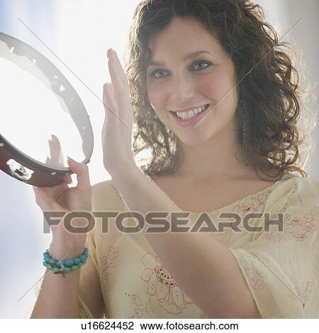 Close up of woman playing tambourine View Large Photo Image Stock Image - Close up of woman playing tambourine. Fotosearch